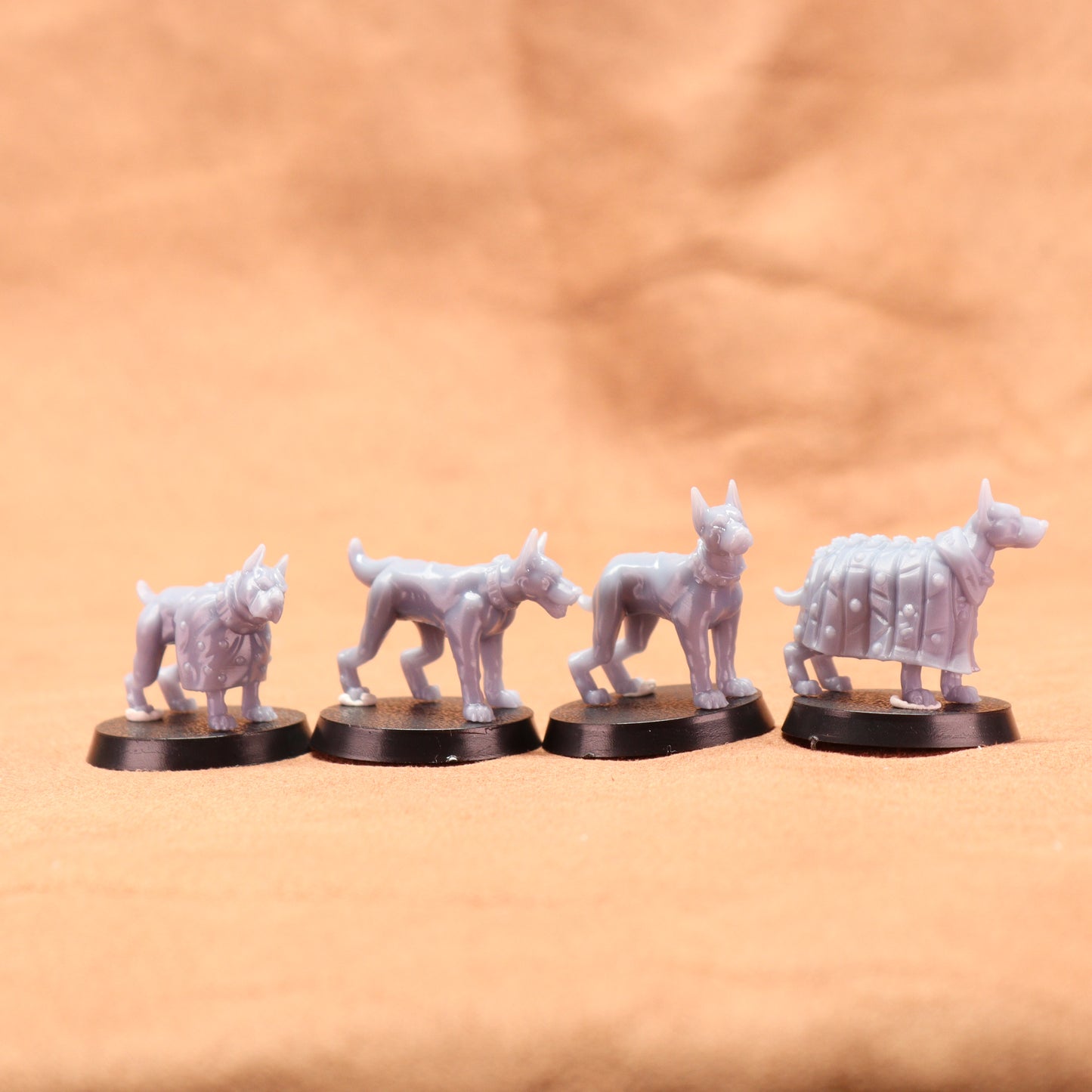 Five white wolf figurines on black bases against a beige background
