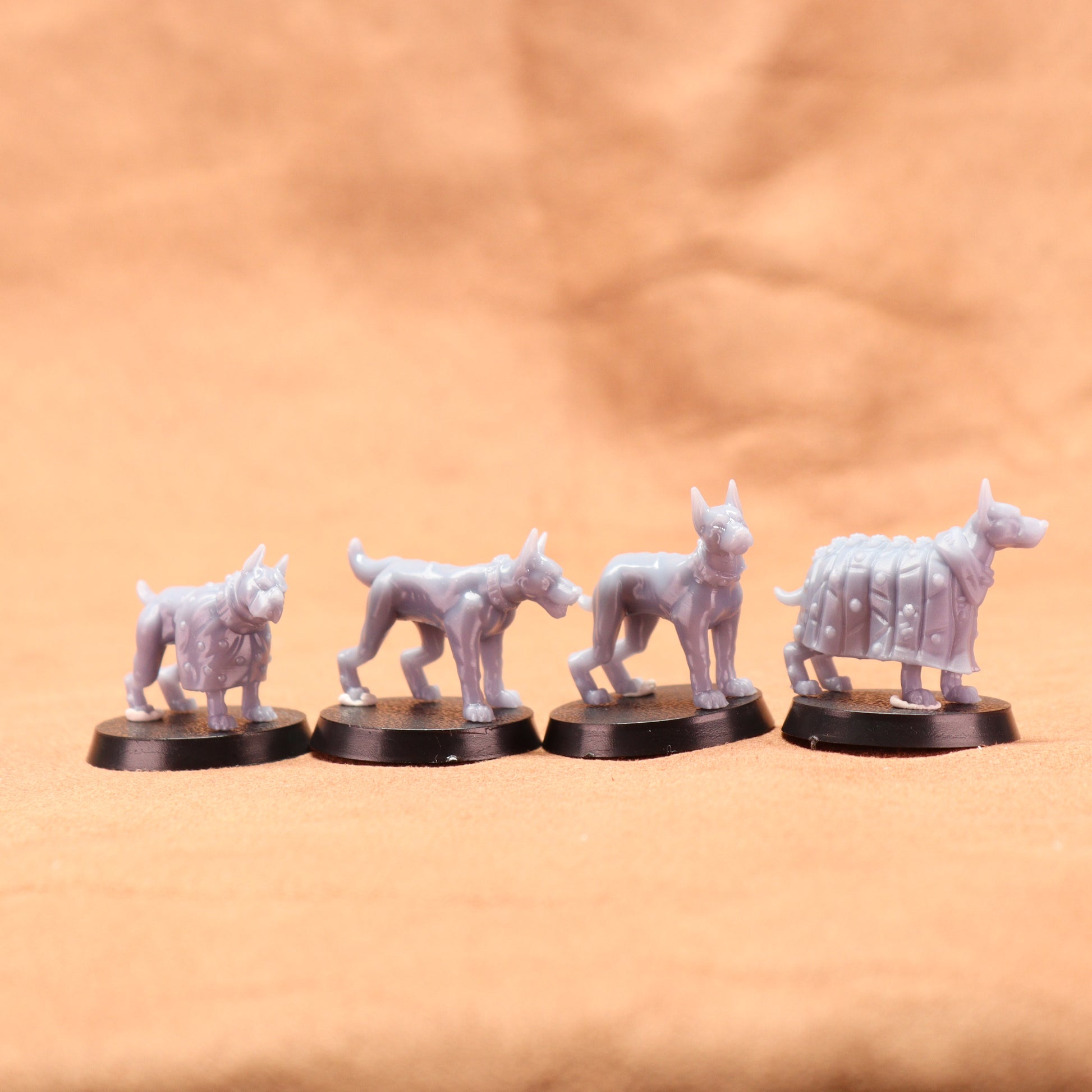 Five white wolf figurines on black bases against a beige background