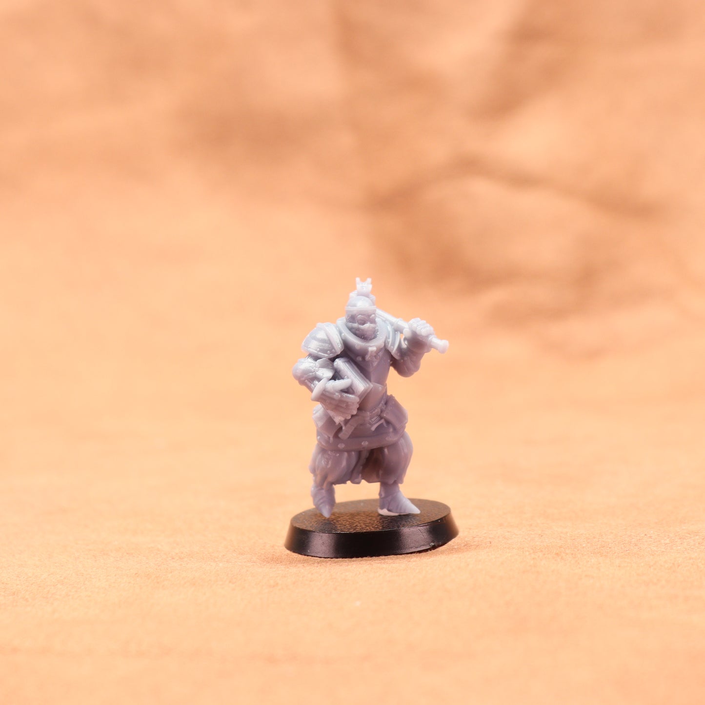 Miniature figurine on a round base against a beige background