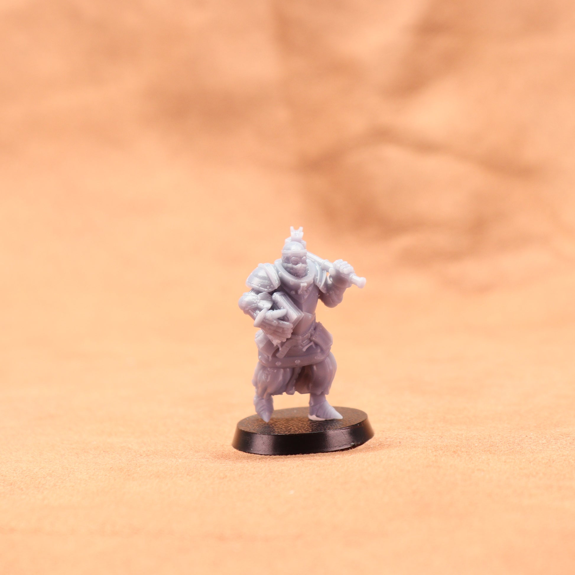 Miniature figurine on a round base against a beige background