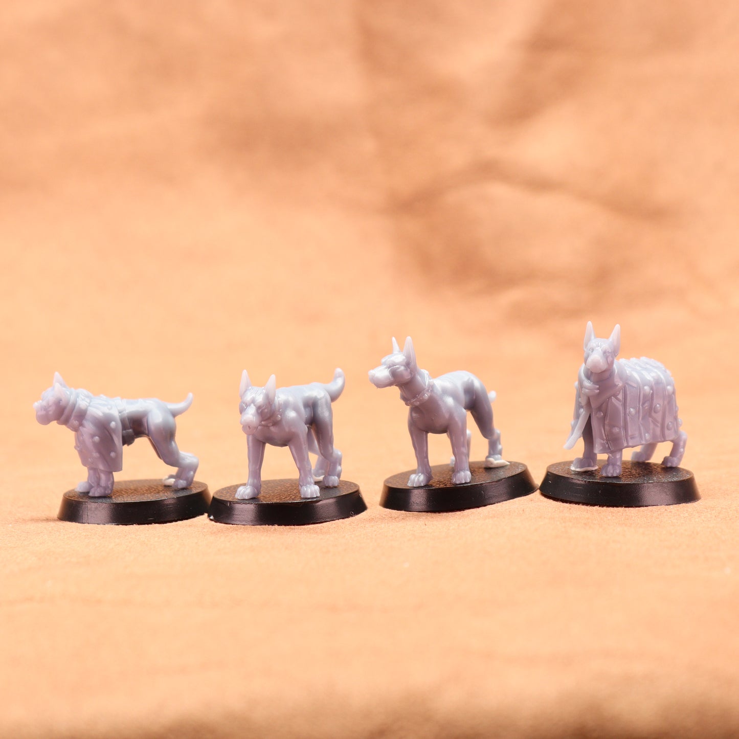 Four white dog figurines on black bases against a beige background