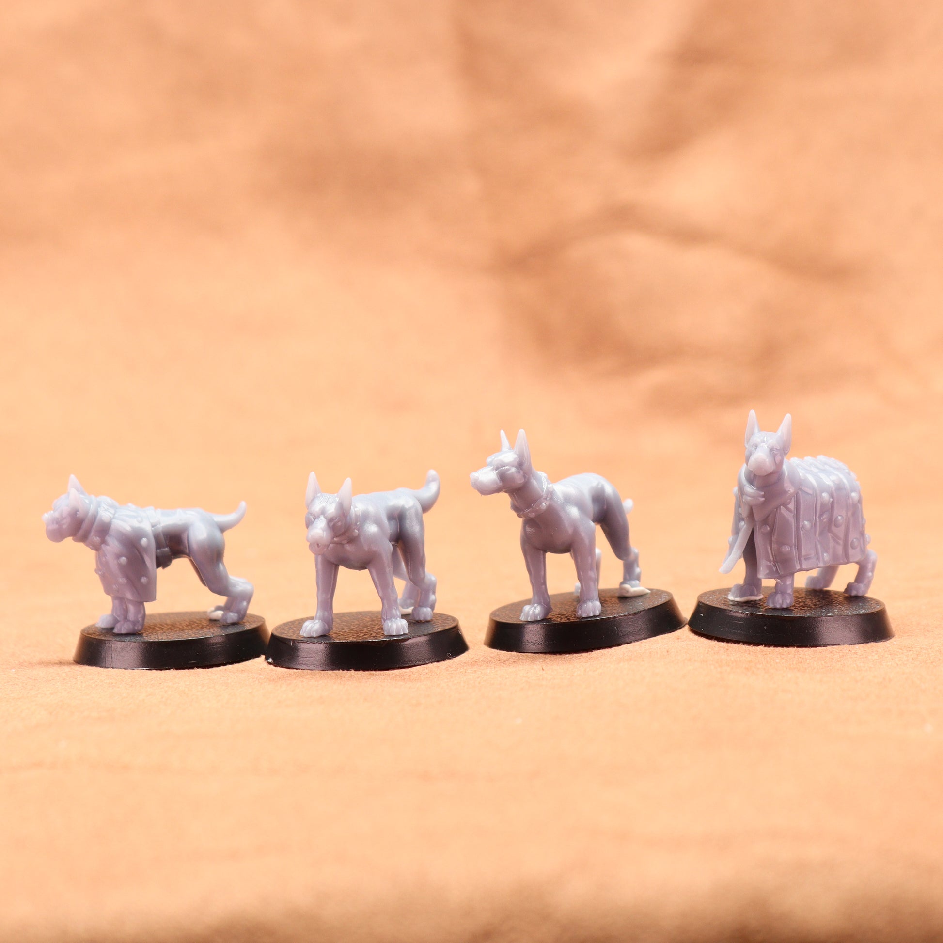 Four white dog figurines on black bases against a beige background