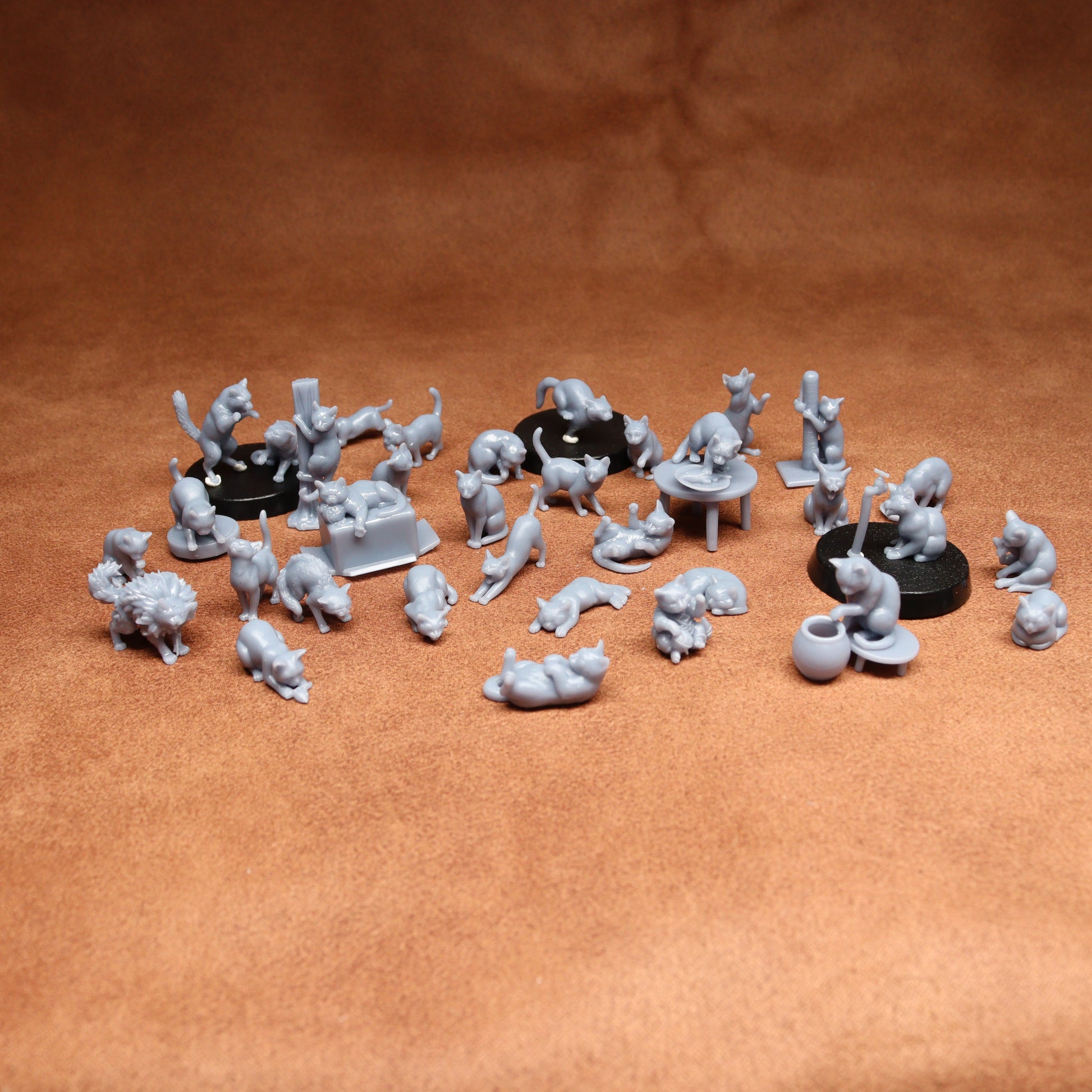 Collection of small gray figurines on a brown surface