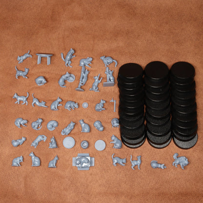 Collection of small animal figurines and black circular objects on a brown surface