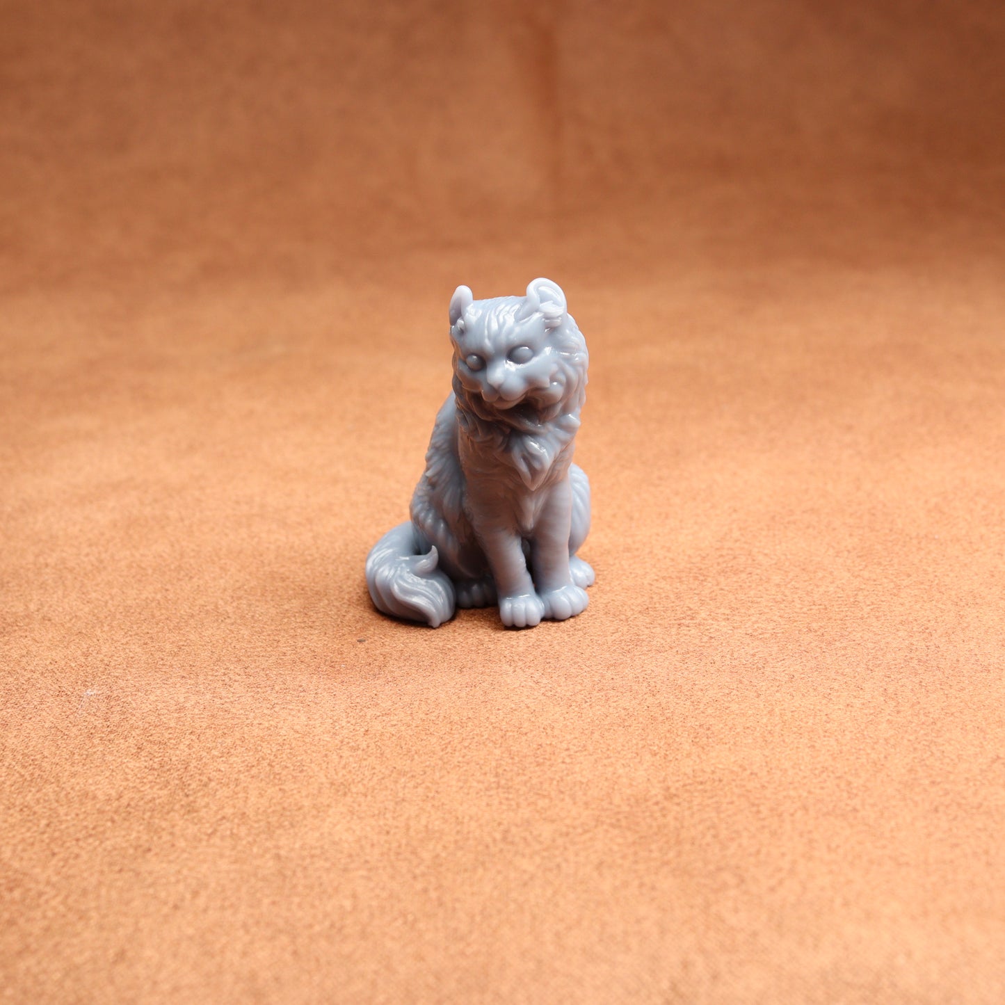 Gray wolf figurine on a brown surface