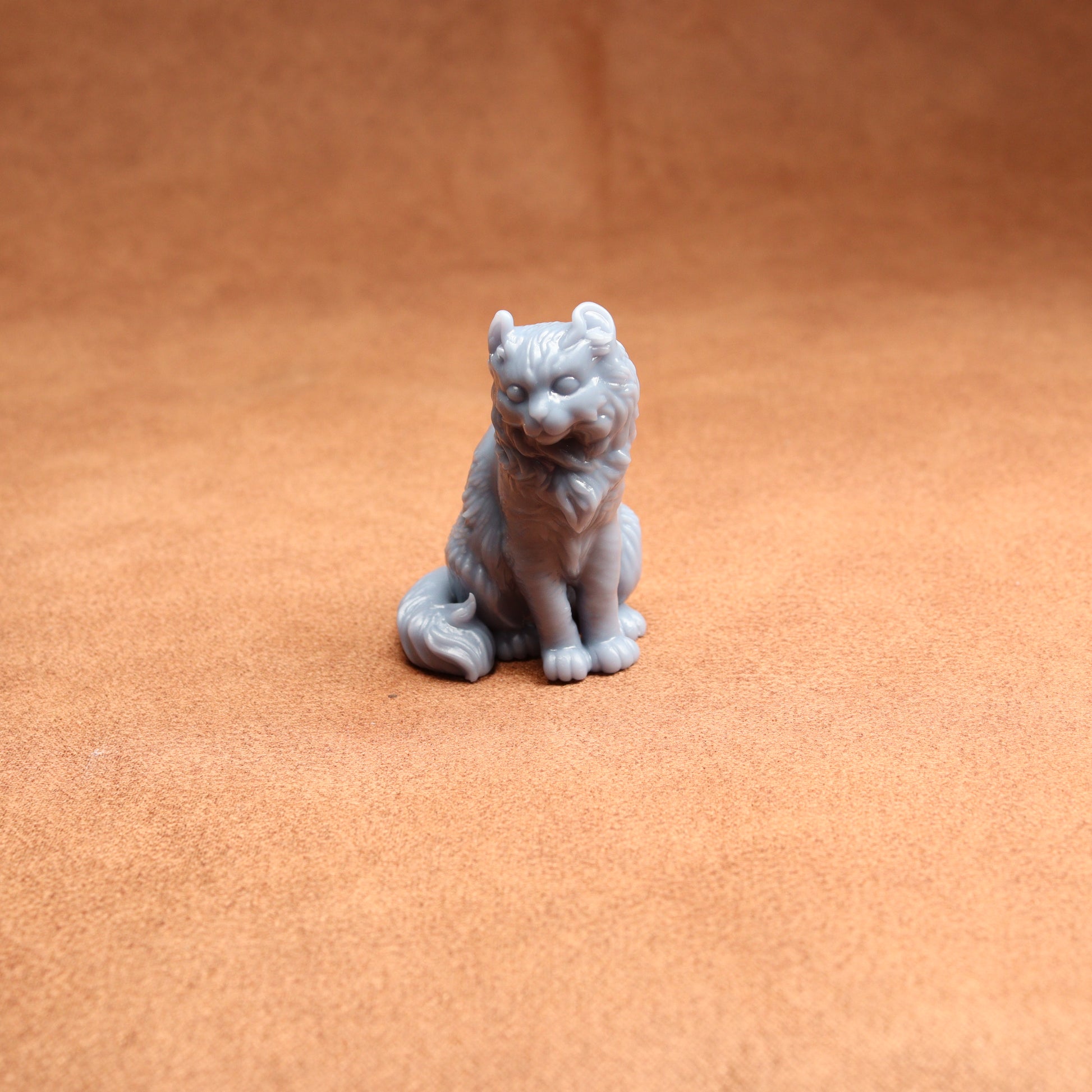 Gray wolf figurine on a brown surface
