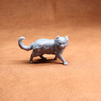 Gray cat figurine on a brown surface