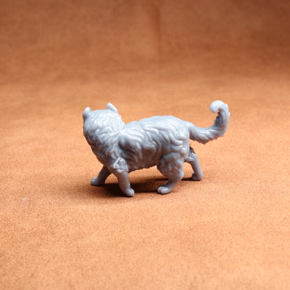 White 3D-printed cat figurine on a brown surface