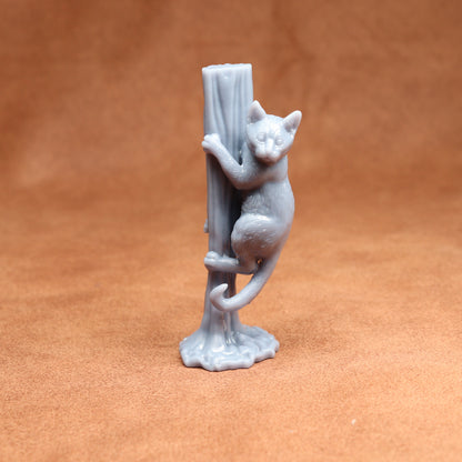 Gray ceramic cat figurine on a brown background