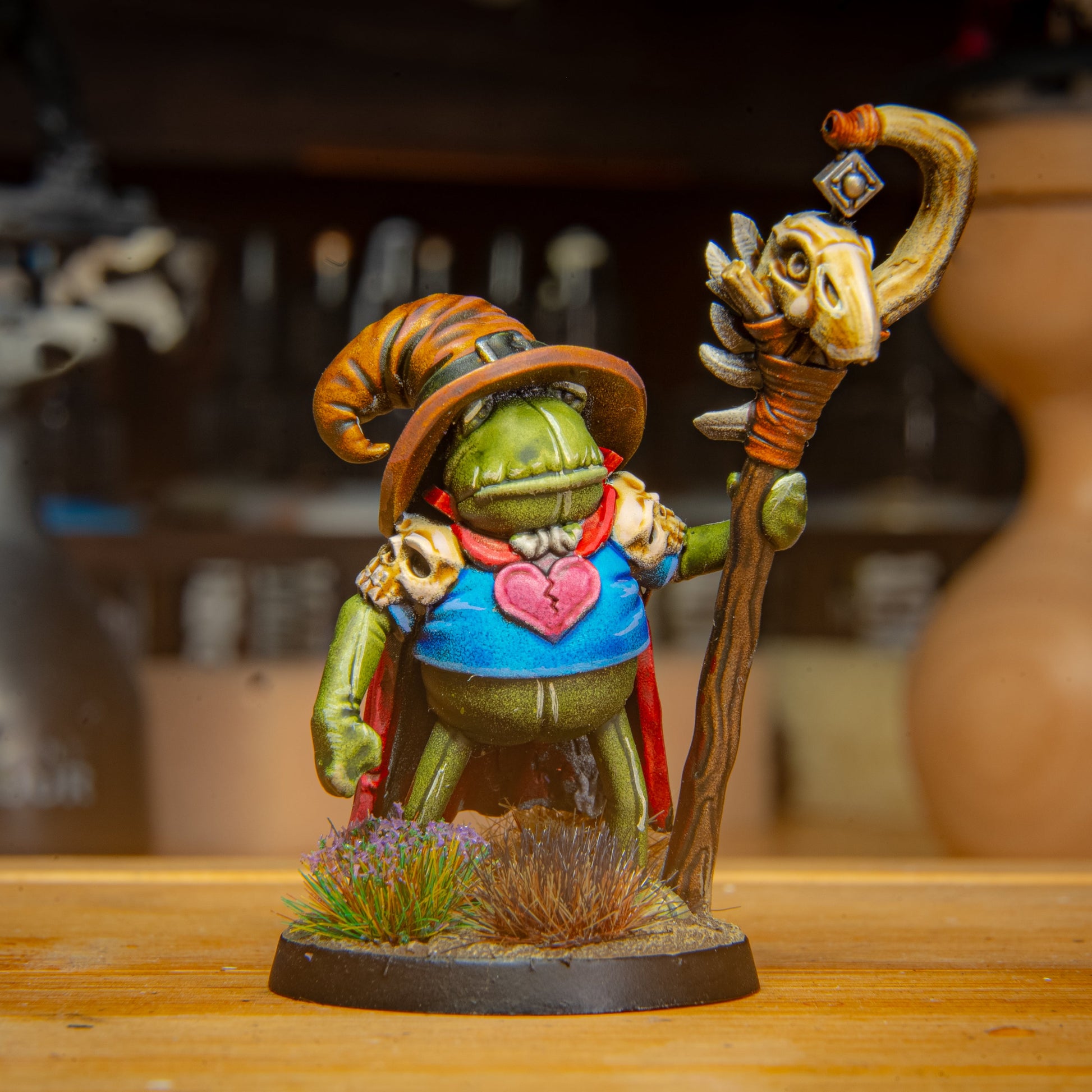 painted frog mAGE miniature on a wooden surface