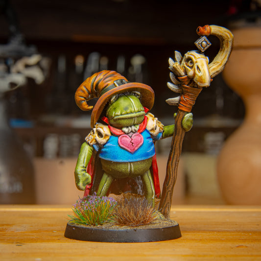 painted frog mAGE miniature on a wooden surface