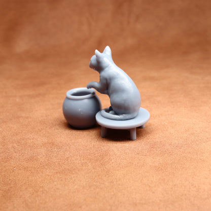 grey miniature cat figure on a brown surface