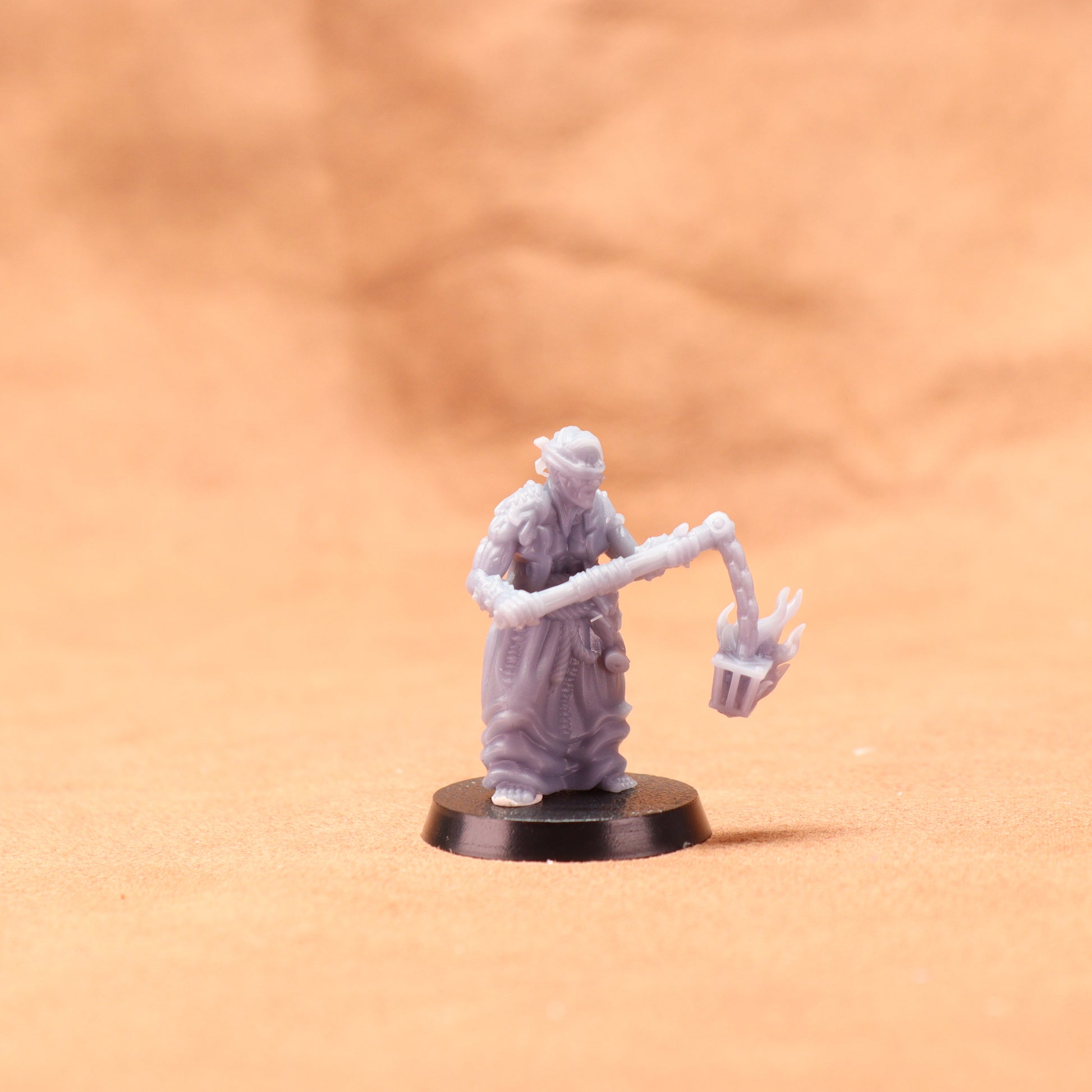 Miniature figurine on a stand against a beige background