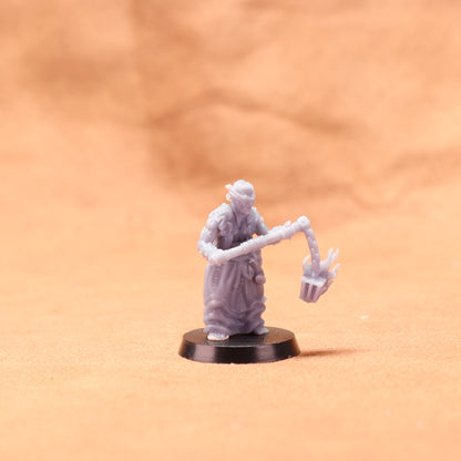 Miniature figurine on a stand against a beige background