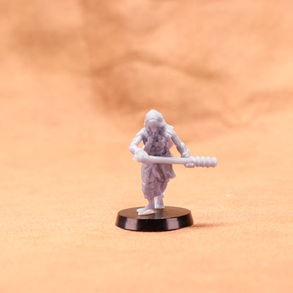 Miniature figurine of a warrior holding a spear on an orange background