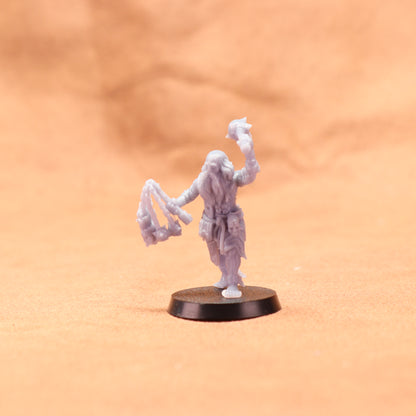 White miniature figure on a round black base against an orange background