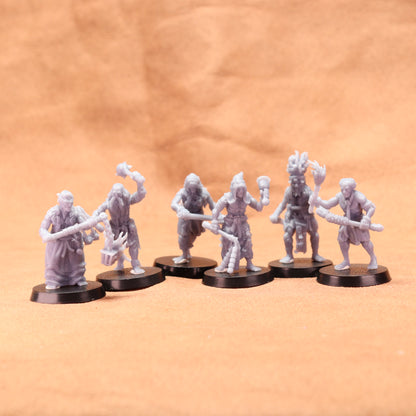 6 grey resin models on black bases on a brown background