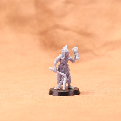 Miniature figurine on a round base against an orange background