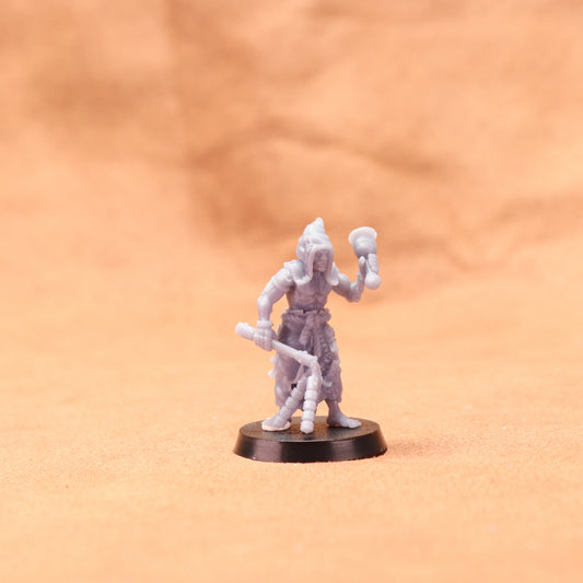 Miniature figurine on a round base against an orange background