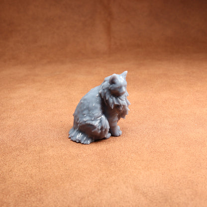 Gray cat figurine on a brown surface