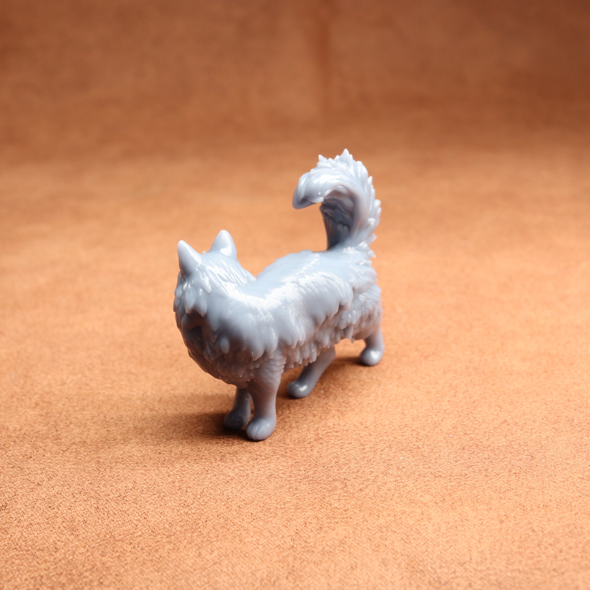 Small white dog figurine on a brown surface