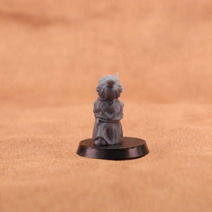 A small gray painted tabletop miniature figurine of a frog-like character in a samurai outfit holding a sword, mounted on a round black base. The background is a warm tan textured surface.