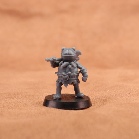 A small gray fantasy warrior miniature figurine holding a double-headed axe, standing on a round black base against a warm tan background.