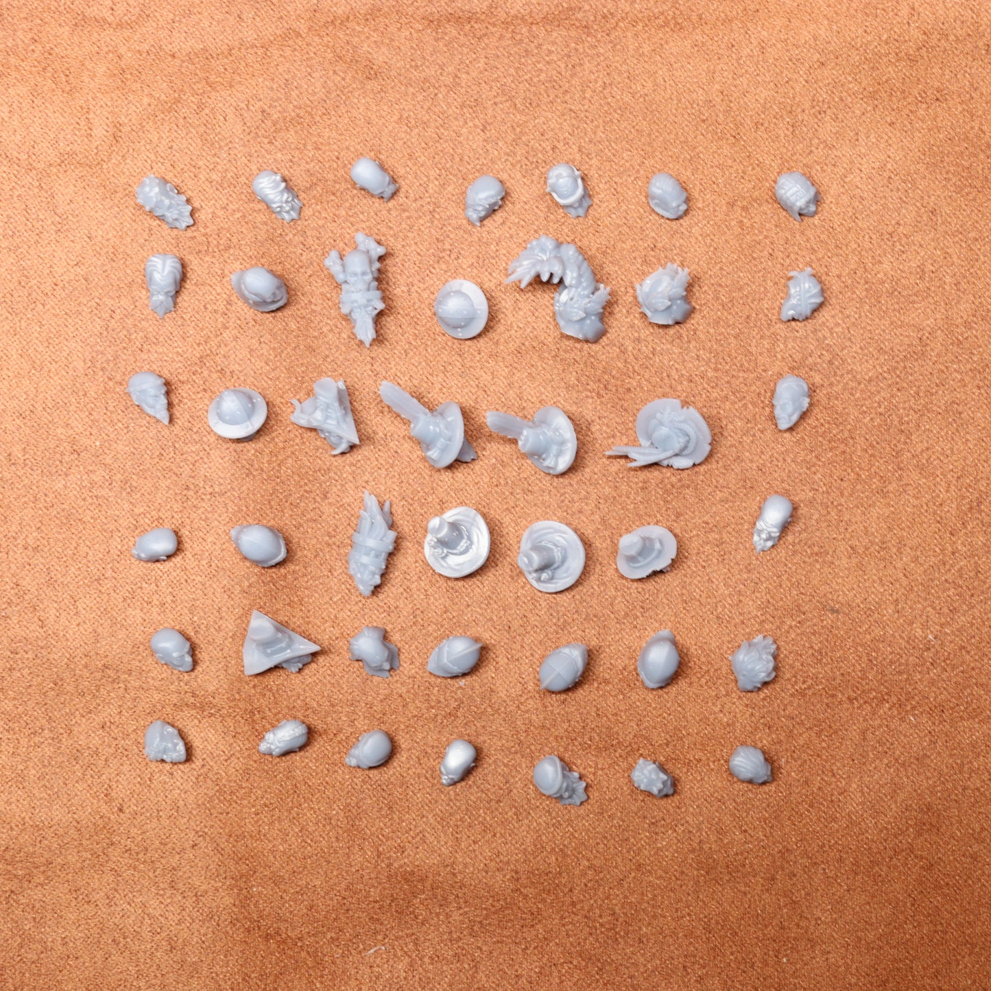 Collection of small white heads on a brown surface