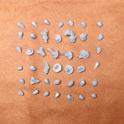 Collection of small white heads on a brown surface