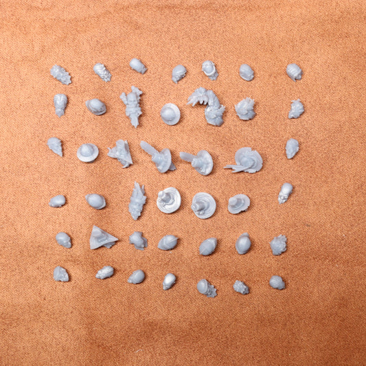 Collection of small white heads on a brown surface