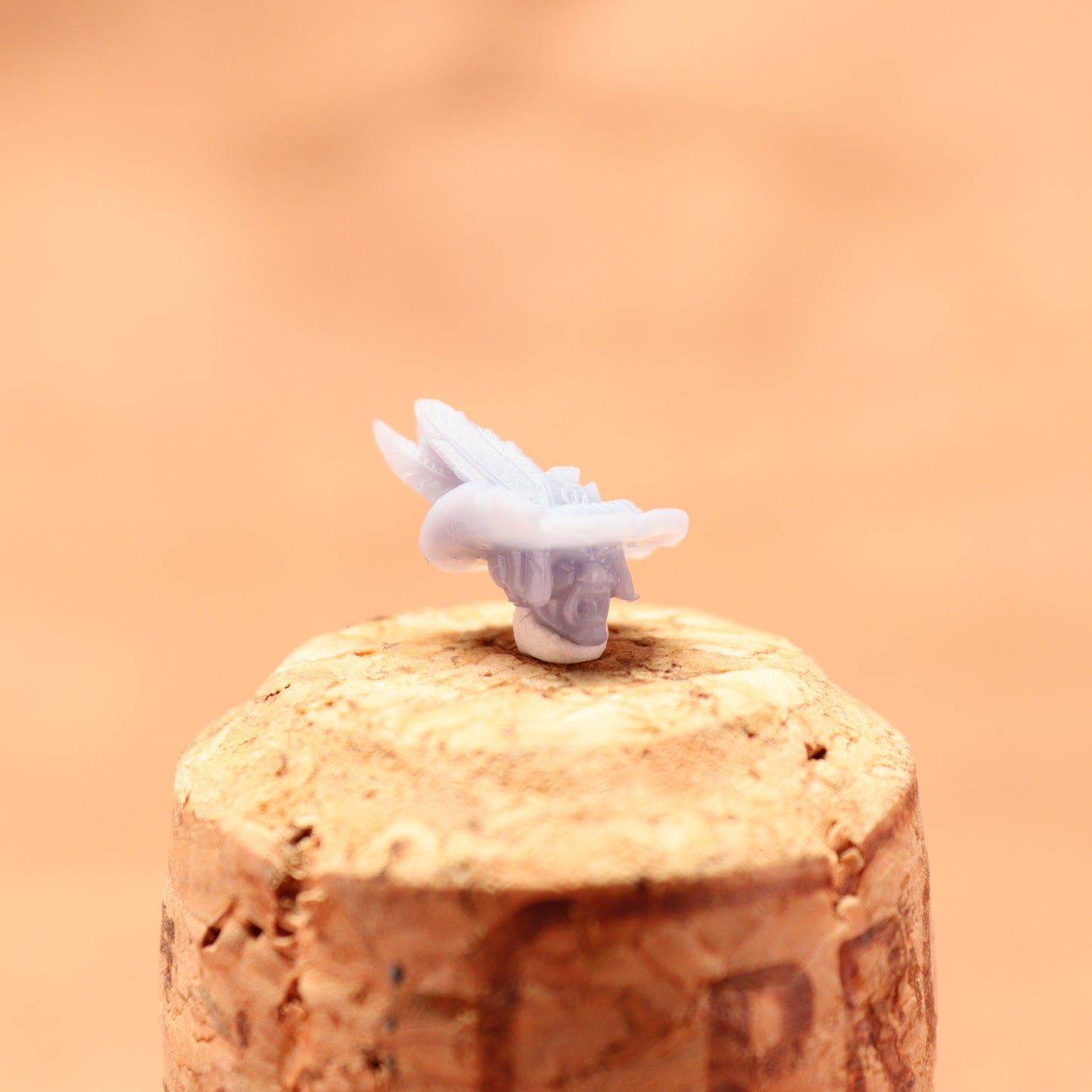 Cork stopper with a white butterfly on a peach-colored background