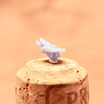 Cork stopper with a white butterfly on a peach-colored background