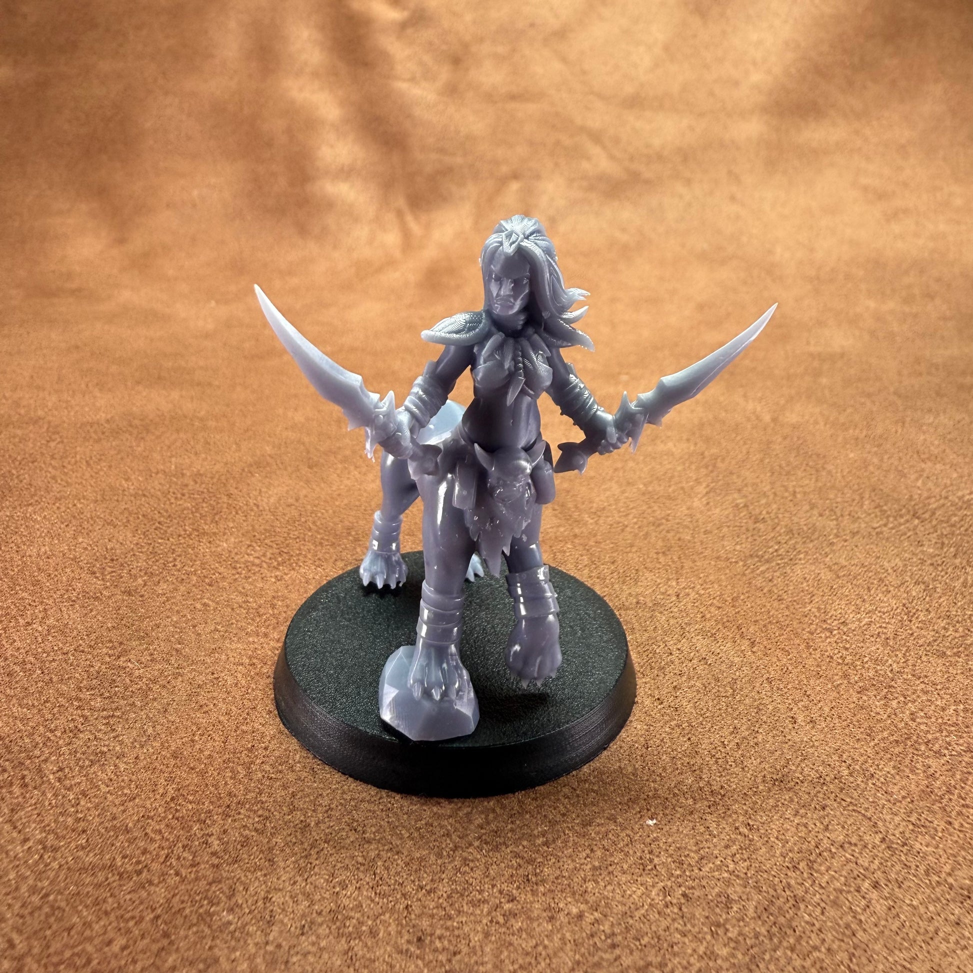 Gray fantasy figurine with horns on a brown surface
