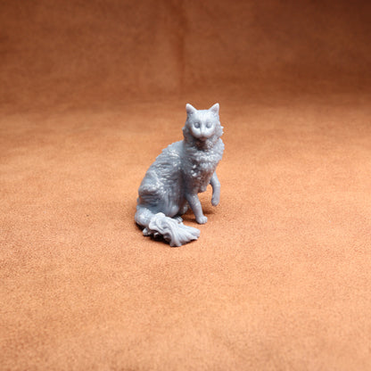 Gray cat figurine on a brown surface