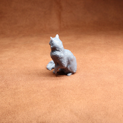 Gray cat figurine on a brown surface