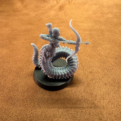Miniature figurine of a warrior on a dragon-like creature with a brown background