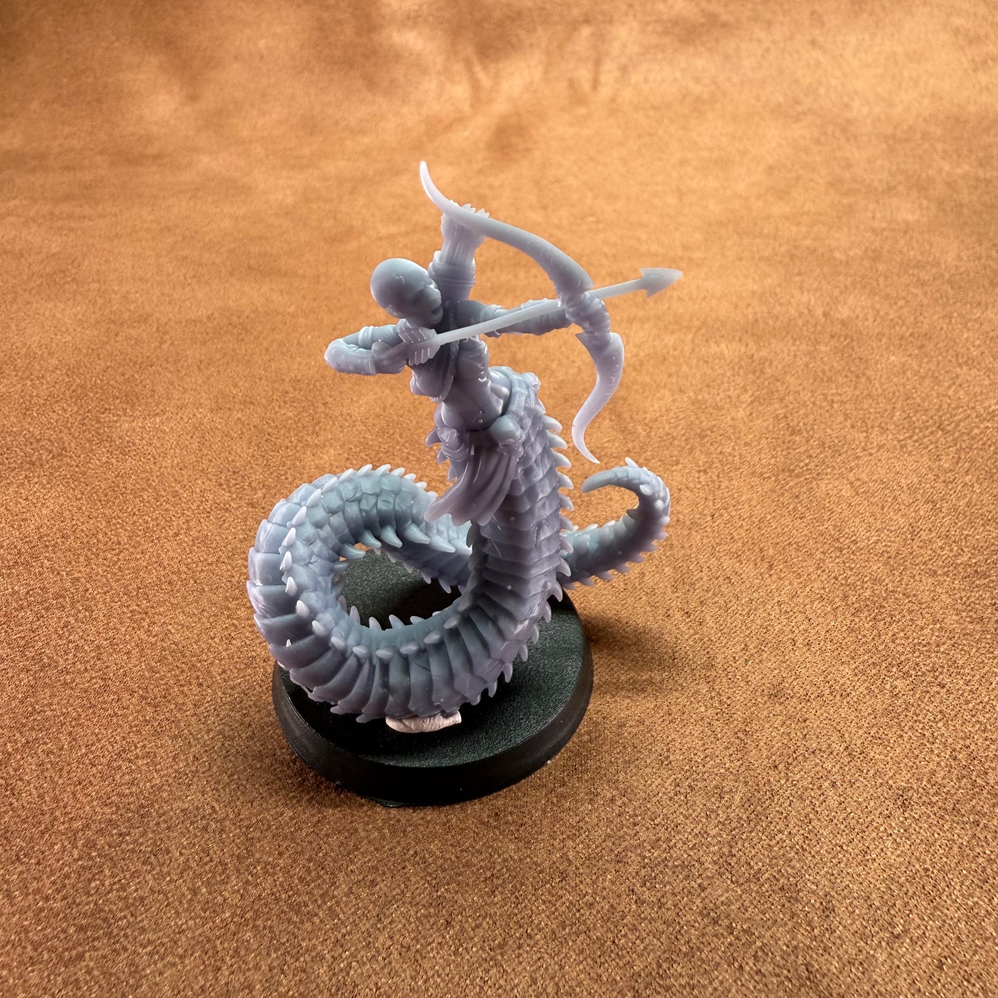 Gray dragon figurine on a brown surface