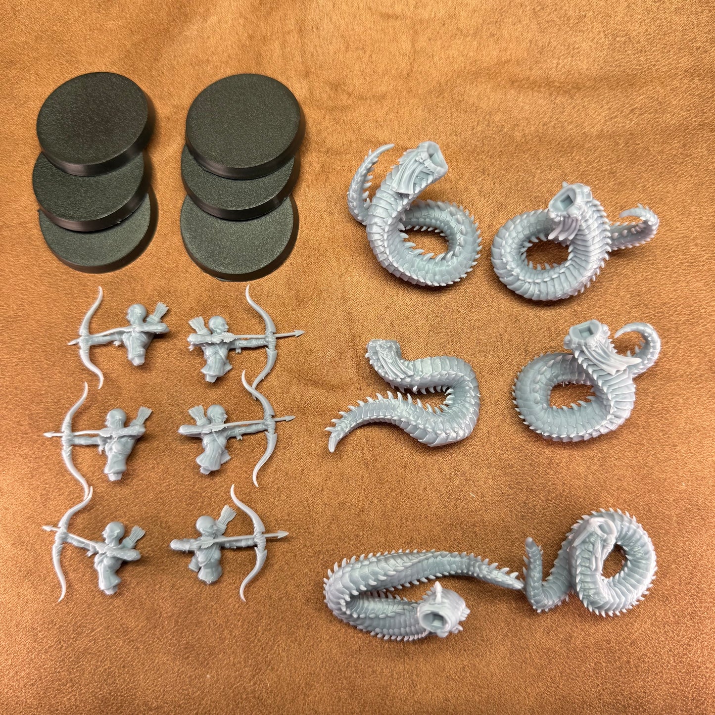 Collection of small figurines and dragon models on a brown surface