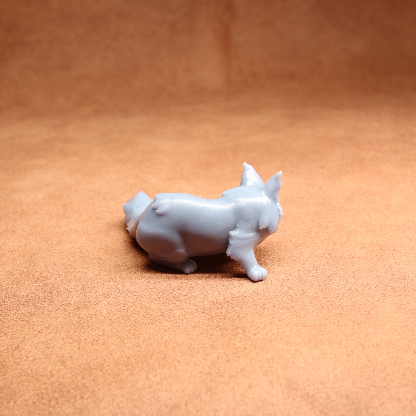 White ceramic dog figurine on a brown surface