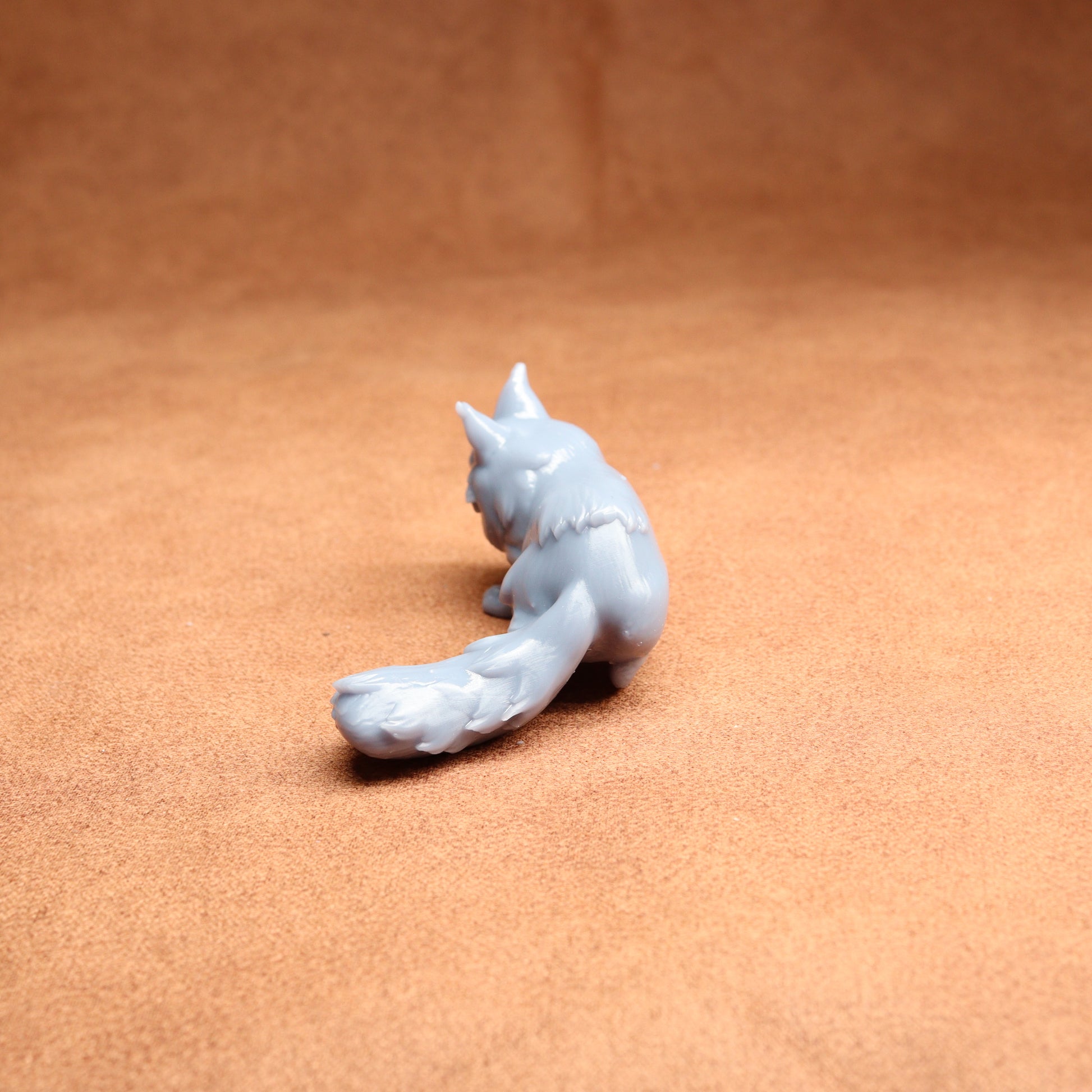 White ceramic fox figurine on a brown surface
