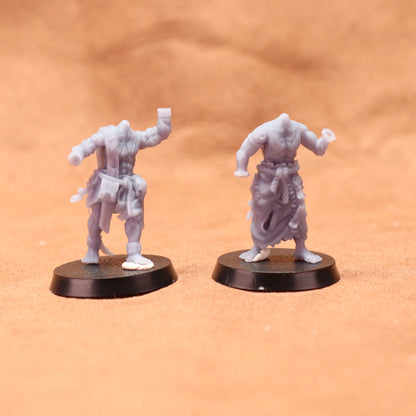 Two gray miniature figures on black bases against a brown background