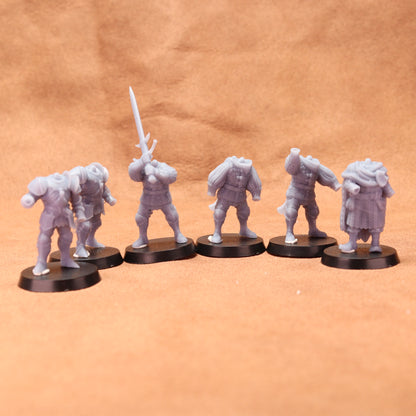 Set of six gray miniature figures on black bases against a brown background