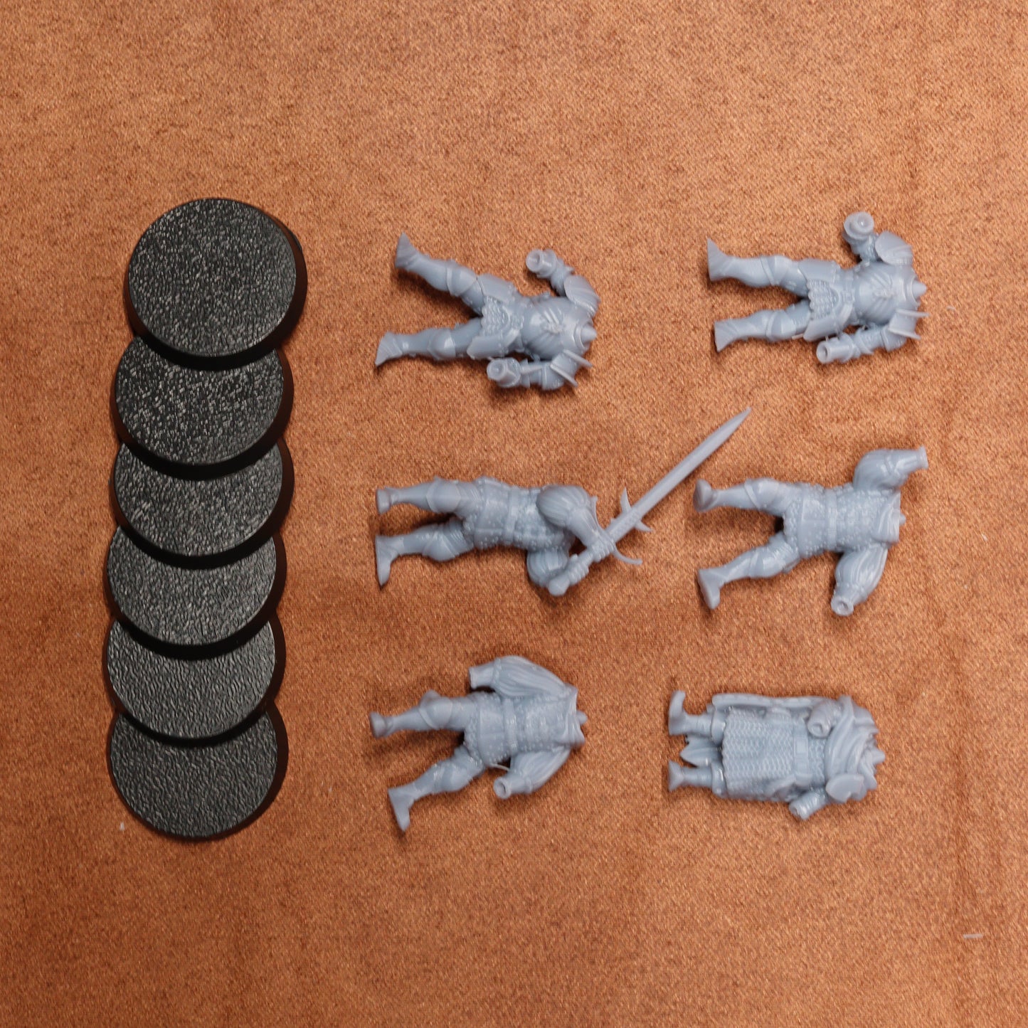 Set of miniature figures and round markers on a brown surface