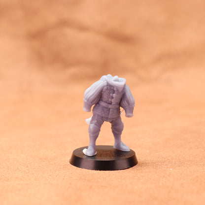 Gray miniature figure on a black base against an orange background