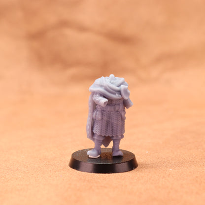Small figurine on a round base against a beige background