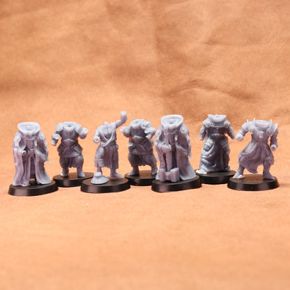 Set of eight gray miniature figures on black stands against a brown background