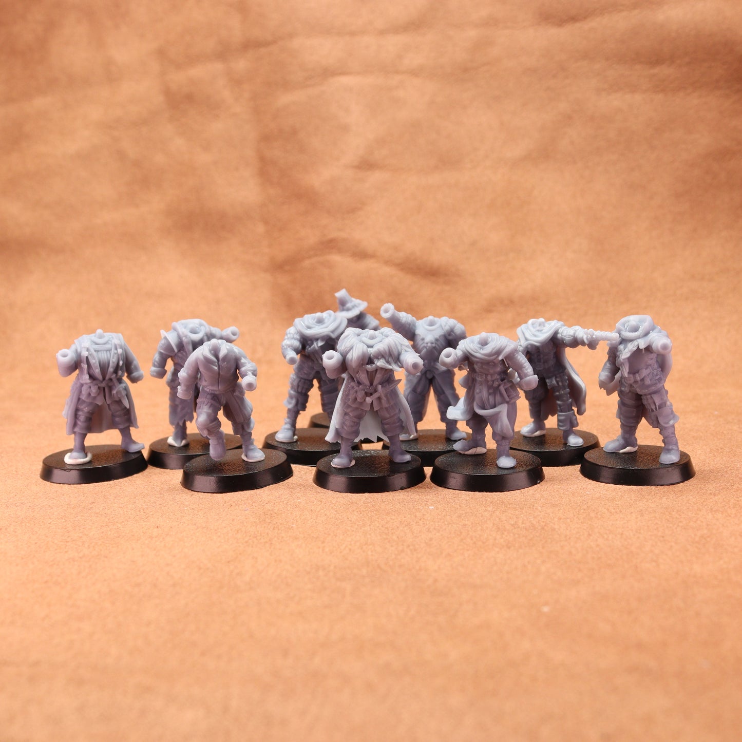 Set of miniature figures on round bases against a brown background