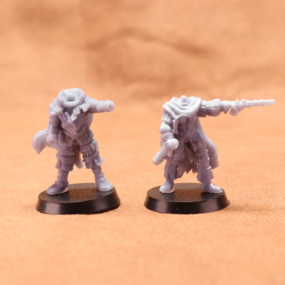 Two miniature figures on black bases against an orange background