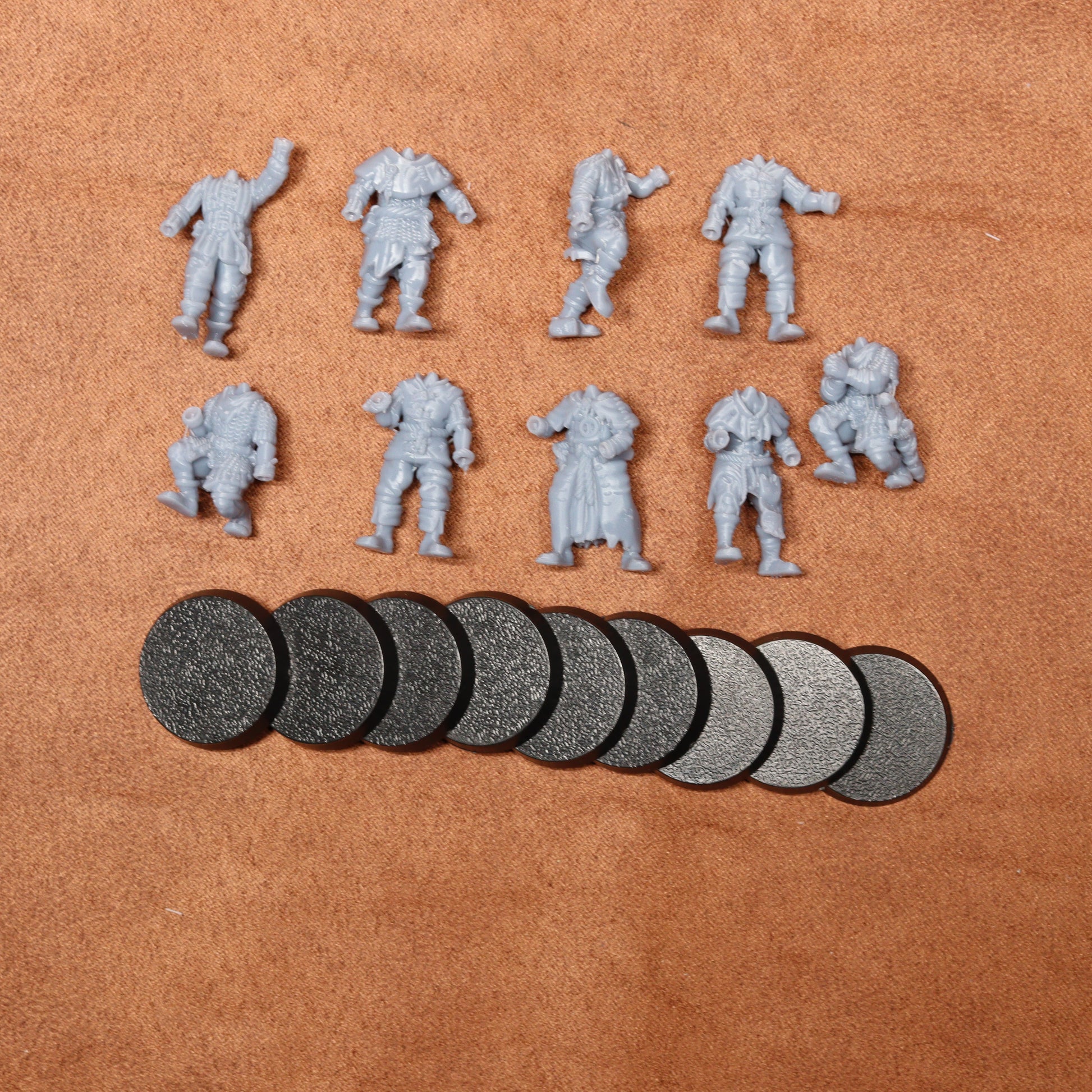 Set of miniature figures and round components on a brown surface