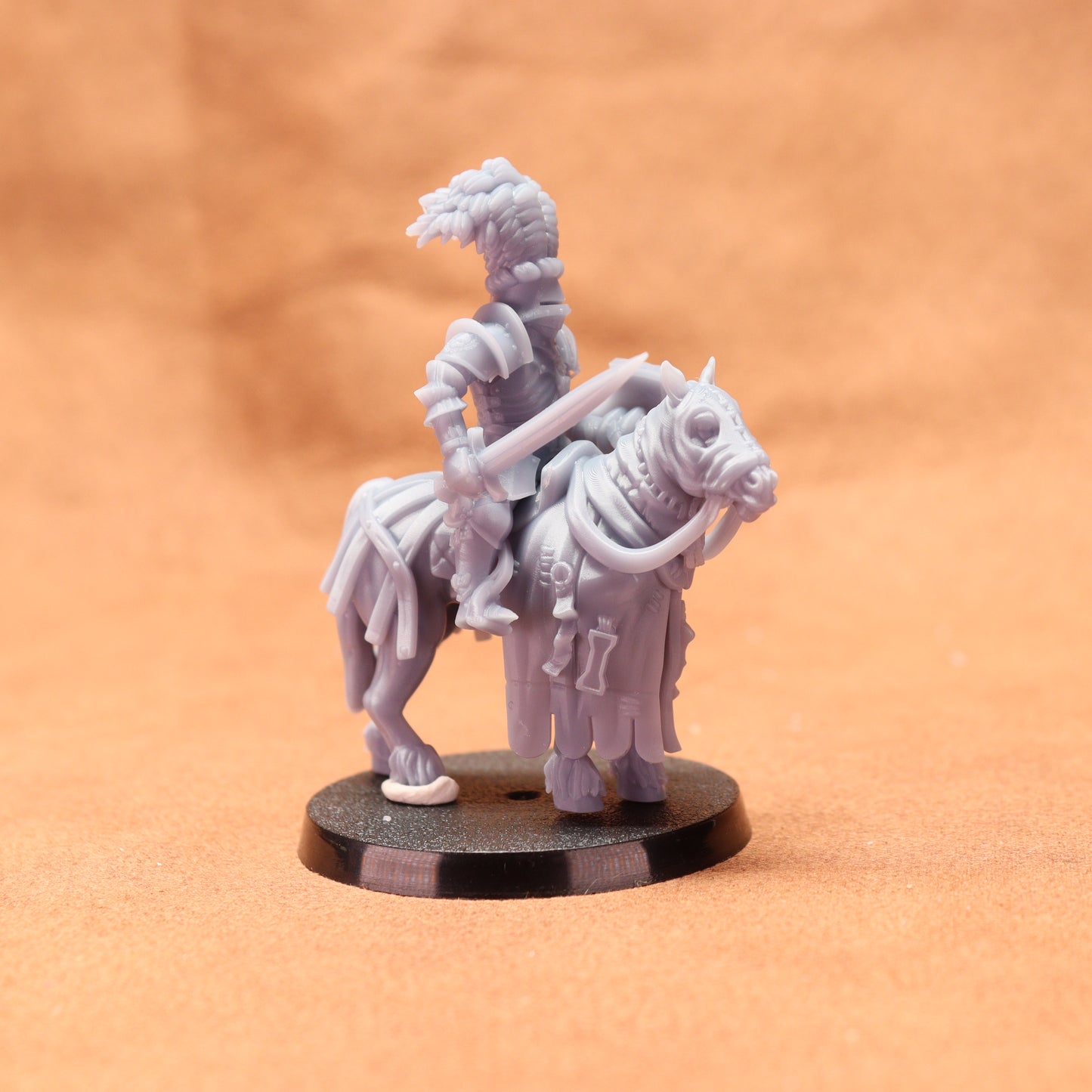 Gray plastic figurine of a warrior on horseback with a brown background